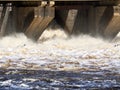 Water discharge at a hydroelectric dam. Seagulls fly over a raging river. Royalty Free Stock Photo