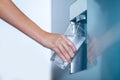 Water dispenser from dispenser of home fridge, Woman is filling a glass with water from the refrigerator