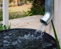 Water drains from the drain pipe into a metal container Royalty Free Stock Photo