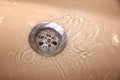 Water drains into the sink, sink and running water Royalty Free Stock Photo