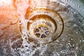 Water drains into the sink, sink and running water for the background, takes care of the water Royalty Free Stock Photo