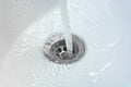 Water drains whirly in the wash sink in the bathroom Royalty Free Stock Photo