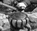 Water dripping through a bamboo pipe into an ornamental stone pot Royalty Free Stock Photo