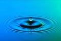 Water drop close up with concentric ripples colourful blue and g Royalty Free Stock Photo