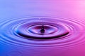 Water drop close up with concentric ripples colourful blue and p Royalty Free Stock Photo