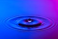 Water drop close up with concentric ripples colourful blue and p Royalty Free Stock Photo