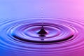 Water drop close up with concentric ripples colourful blue and p Royalty Free Stock Photo