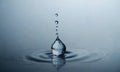 Water drop close up. Splash effect after collision a falling drops with water Surface Royalty Free Stock Photo