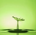 Water Drop Collisions Macro Photography with green  background Royalty Free Stock Photo