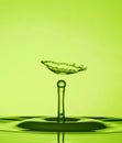 Water Drop Collisions Macro Photography with green  background Royalty Free Stock Photo