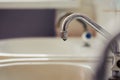 Water drop drips from rusty steel tap in bathroom or kitchen Royalty Free Stock Photo