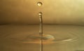 Water drop fall down and splash on surface Royalty Free Stock Photo