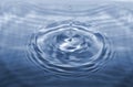 Water drop falling making droplet splash and waves clean and fresh concept. Royalty Free Stock Photo