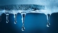 A water drop falling in slow motion from the tip of an icicle, symbolizing the transition from cold to warmth beauty Royalty Free Stock Photo