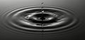 Water drop falls into dark liquid creating concentric ripples. Fluid dynamics captured in motion. Abstract background with Royalty Free Stock Photo