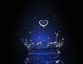 Water drop in form of heart in blue spot light
