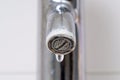 Water drop leaking of a broken tap. Bathroom water leak, corrosion close up Royalty Free Stock Photo