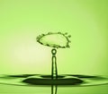 Water Drop Collisions Macro Photography with green  background Royalty Free Stock Photo