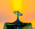 Water Drop Collisions Macro Photography with orange background Royalty Free Stock Photo