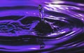 Water drop on purple background Royalty Free Stock Photo