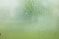 Water drop of rain on window glass burred garden background. Royalty Free Stock Photo