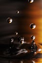 Water drop in rippled liquid Royalty Free Stock Photo