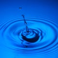 Water drop splash blue colored Royalty Free Stock Photo