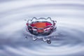 Water drop splash crown in blue and red tones Royalty Free Stock Photo