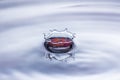Water drop splash crown in blue and red tones Royalty Free Stock Photo