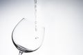 Water drop into wine glass on white Royalty Free Stock Photo