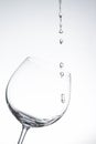 Water drop into wine glass on white Royalty Free Stock Photo