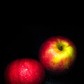 Water droplet on glossy surface of red apple on black background Royalty Free Stock Photo
