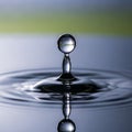 The water droplet is perfectly reflected below, emphasizing symmetry and Royalty Free Stock Photo