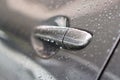 The water droplet from raindrops on silver color car`s body, the dew cover on the gray back door handle of the car, close up phot Royalty Free Stock Photo