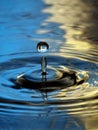 Water Droplet Ripple blue yellow column drop Royalty Free Stock Photo