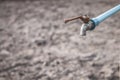 Water droplets on arid soil. Royalty Free Stock Photo