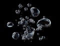 Water droplets and bubbles exploding on black background Royalty Free Stock Photo