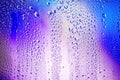 Water droplets condense on the colorful glass surface Royalty Free Stock Photo