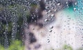 Water droplets condensed on the glass surface in the morning. View through the window in the rainy season Royalty Free Stock Photo