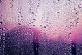 Water droplets condensed on the glass surface in the evening. View through the window in the rainy season Royalty Free Stock Photo