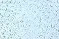 Water droplets on glass and on blue sky background Royalty Free Stock Photo