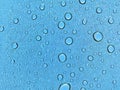 Water droplets on glass, blue sky