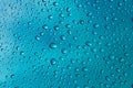 Water droplets on glass on blue stainless steel background  Background  Wallpaper  Patter. Royalty Free Stock Photo