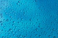 Water droplets on glass on blue stainless steel background  Background  Wallpaper  Patter. Royalty Free Stock Photo