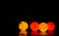 Water droplets on a glass with bokeh lights and reflection on a dark background