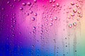 Water droplets on glass surface. Colorful blurred abstract of water drops texture on pink magenta background Royalty Free Stock Photo