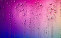 Water droplets on glass surface. Colorful blurred abstract of water drops texture on pink magenta background Royalty Free Stock Photo