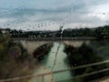 Water droplets on glass window during raining with blurry background Royalty Free Stock Photo