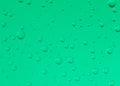 Water droplets on green glass