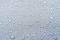 Water droplets on grey fiber waterproof fabric.